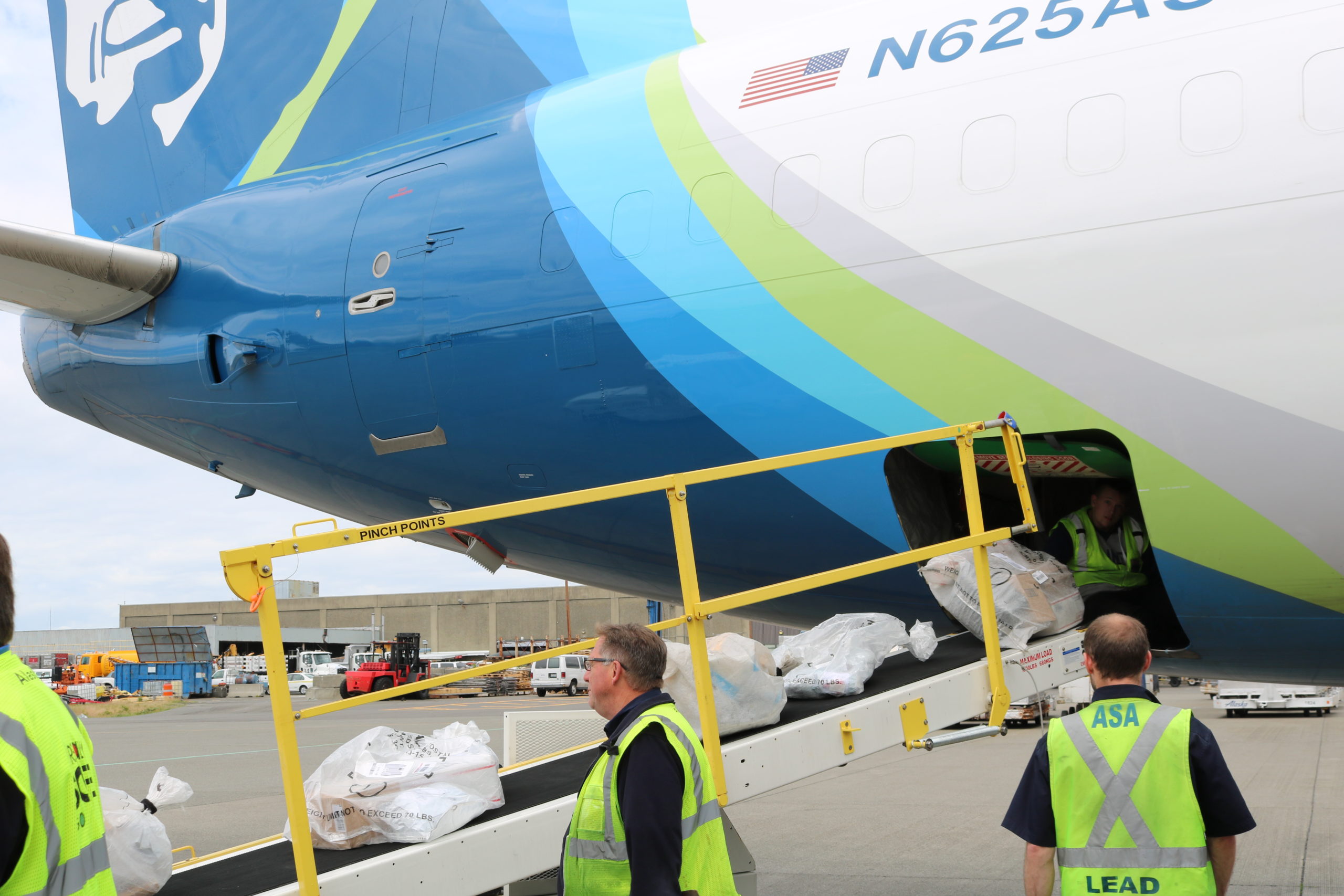 Alaska's recently converted 737-700F's belly getting loaded with Alaska-bound parcels