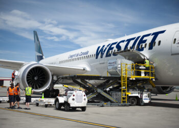 A WestJet plane is loaded with cargo