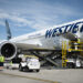 A WestJet plane is loaded with cargo