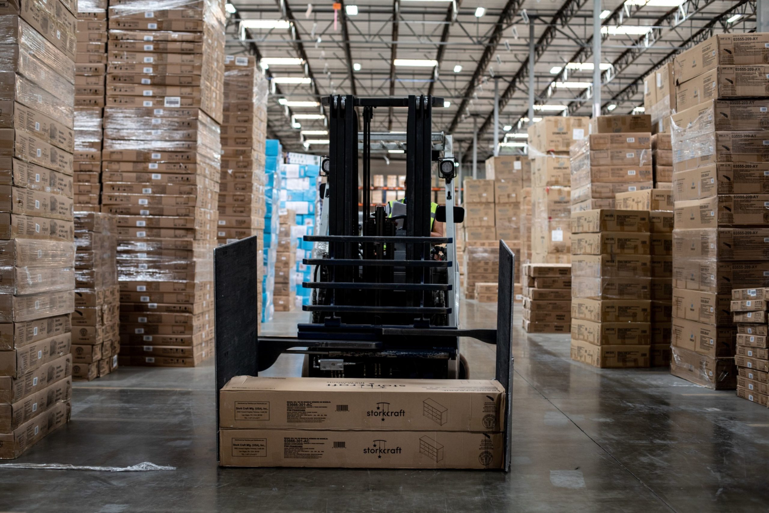 An employee is moving  order shipments that will be labeled and prepared to be delivered to online customers at the Stork Craft Manufacturing Inc facility in Chino, California, U.S. on Monday Sept. 23, 2019. Photographer: Martina Albertazzi/Bloomberg