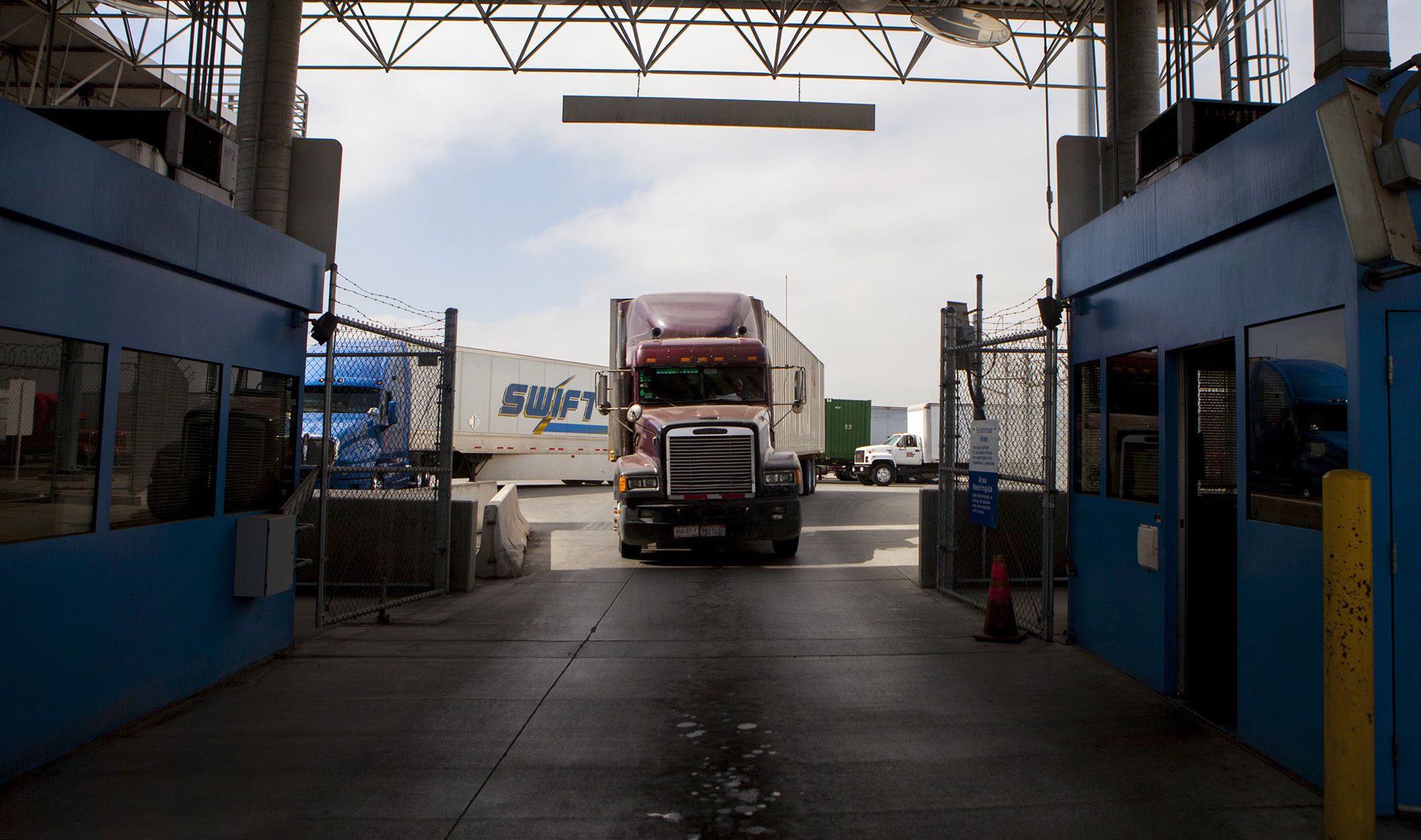 Truck drivers wait to speak to a U.S. Customs and Border Protection officer soon after arriving in the U.S. from Mexico at the Otay Mesa Port of Entry cargo facility in San Diego, California, U.S., on Friday, June 7, 2013. Mexico reported a revised trade deficit of $1.2 Billion for April, the national statistics agency, known as Inegi, said on its website. Photographer: Sam Hodgson/Bloomberg