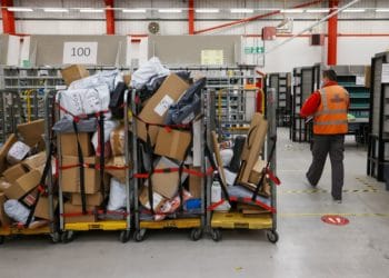 An employee passes trolleys loaded with parcels the Royal Mail Plc sorting office in Chelmsford, U.K., on Thursday, May 13, 2021. Photo: Bloomberg