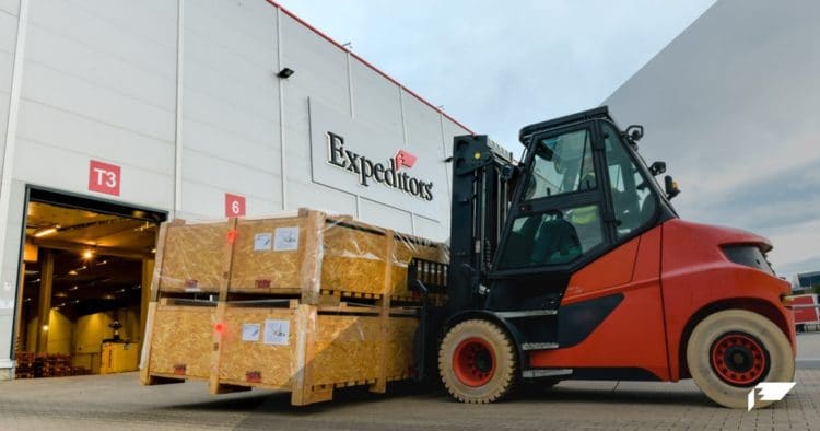 An Expeditors warehouse behind a forklift moving cargo