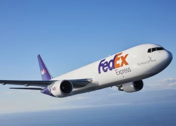 A FedEx plane flies through the air.