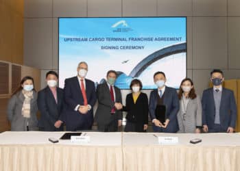 Airport Authority Hong Kong and Cathay Pacific officials sign an agreement.