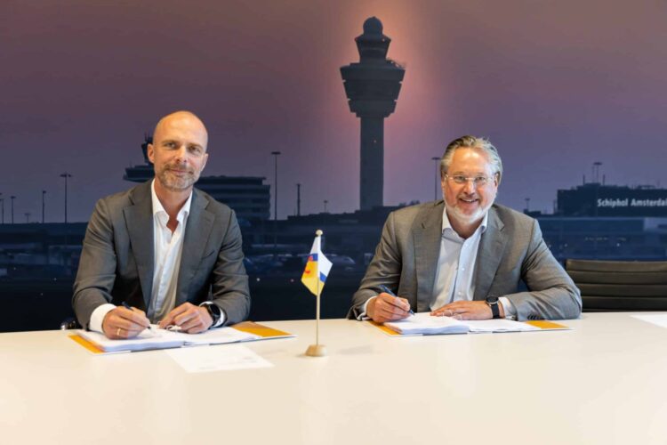 Representatives from Royal Schiphol Group and MST sign papers.