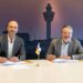 Representatives from Royal Schiphol Group and MST sign papers.
