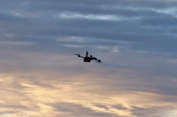 A Skydio drone flies at dusk