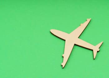 A wooden airplane against a green background