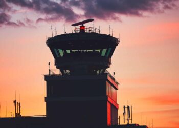 An air traffic control tower in the dusk
