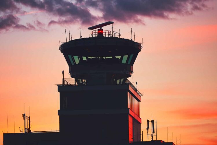 An air traffic control tower in the dusk