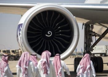 Saudi visitors in front of a jet engine