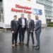 Four men stand outside a Dusseldorf Airport Cargo building