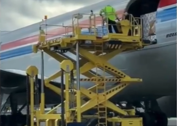 A high loader loading cargo onto an airplane