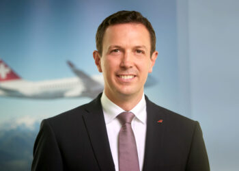 Jens Fehlinger in front an image of a SWISS plane