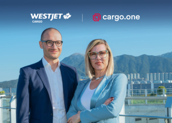 Moritz Claussen and Kirsten de Bruijn stand together in front of railing with mountains in the background; the WestJet Cargo and cargo.one logos are above them