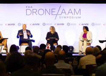 Panelists speak on a stage