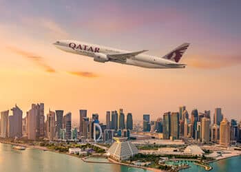 A Qatar Airways Cargo plane soars above Doha