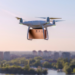 A drone carrying a package flies over a city with a river