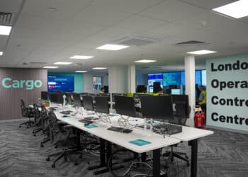 A view of IAG Cargo's London Operation Control Centre showing several computers down a long table